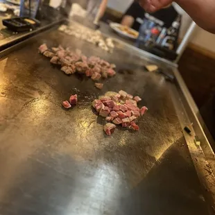 a person cooking food on a grill