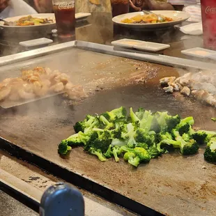 broccoli being cooked on a grill