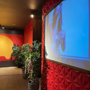 a man standing in front of a screen