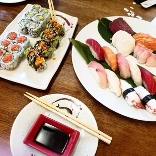 a plate of sushi and chopsticks