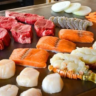 a variety of sushi and steaks