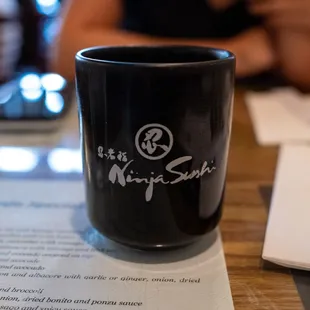 a black coffee cup on a table