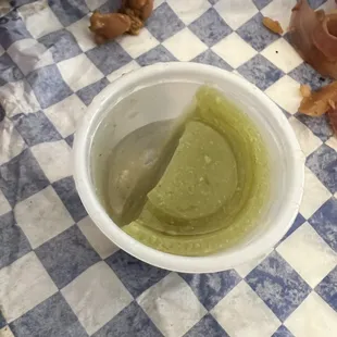  cup of green liquid on a checkered tablecloth