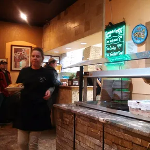 a woman standing in front of a counter