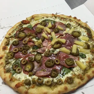 Salami, Canadian bacon, fresh spinach, jalapeños, half olive, half pineapple, pesto for sauce, mozzarella cheese. Damn good.