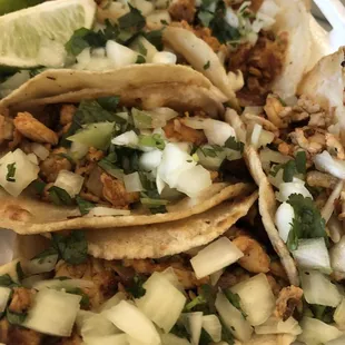 Chicken tacos with onion and cilantro