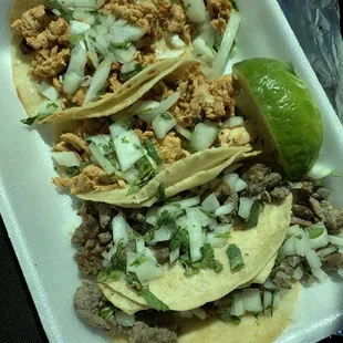 a plate of tacos and a lime