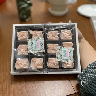 a person holding a box of soaps