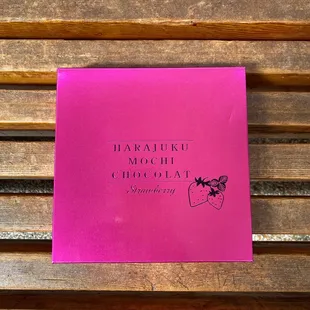 a pink book on a wooden bench