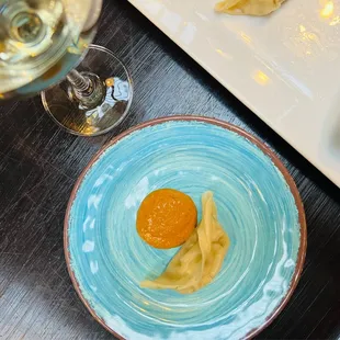 a plate of food and a glass of wine