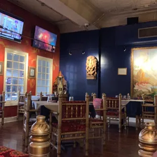 a restaurant with a large painting on the wall