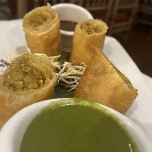 a plate of food with dipping sauce