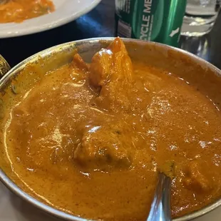 a bowl of curry and a plate of food