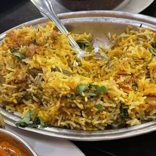a plate of rice and a bowl of curry