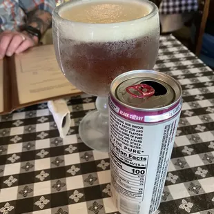 a glass of beer and a can