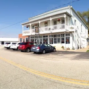 two cars parked in front of the inn
