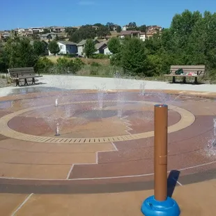 Water feature spraying. It sprays low then high then really high. Turn on sprayers by pressing the button on the pole.