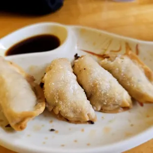 three dumplings on a plate