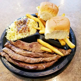London Broil (Marinated Beef Strips) with Rice &amp; Gravy, French Fries and Dinner Rolls.