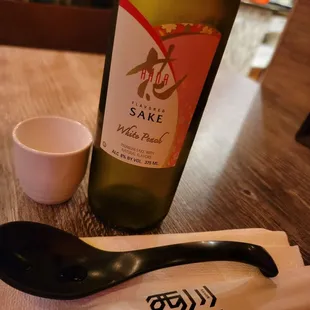 a bottle of sake and a spoon