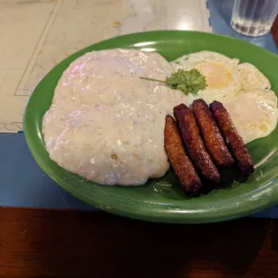 The biscuit &amp; gravy combo with eggs over easy and link sausage.