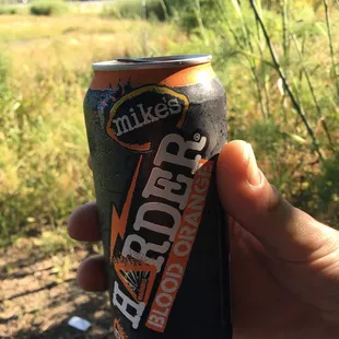 a person holding a can of drink