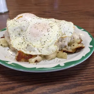 Biscuits with hash browns and white milk gravy with two eggs cooked the way you want over the top