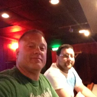 two men sitting at a bar