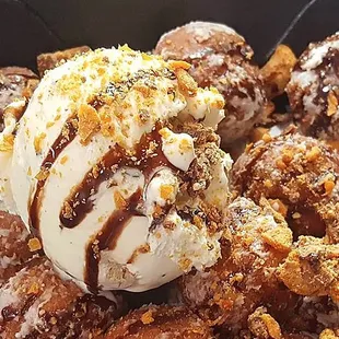 a bowl of doughnuts with a scoop of ice cream