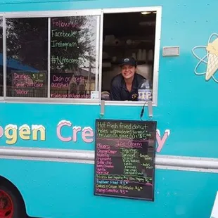 a woman in a blue food truck