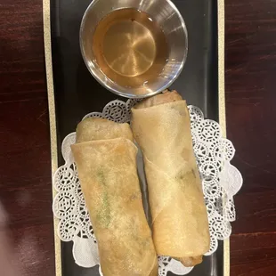 two fried spring rolls and a cup of tea
