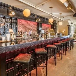 a long bar with red stools