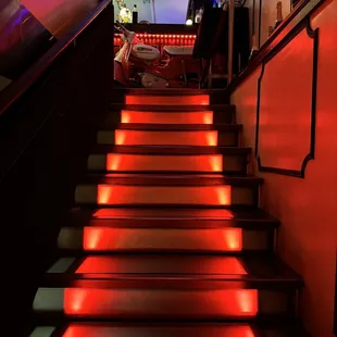 a set of stairs lit up with red lights