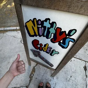 a person standing in front of a sign