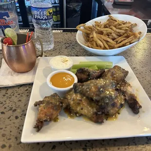 Garlic Parmesan Baked wings and french fries. Drink: Piña Colada Mule