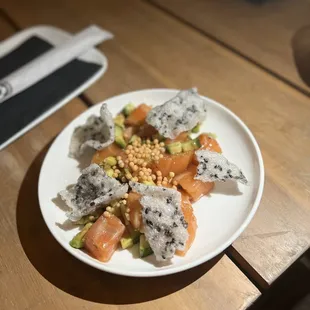 SALMON POKE BITES $12.00 Scottish salmon, avocado, cucumber, green onions on a rice crisp
