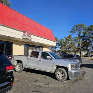 a pickup truck parked in front of a restaurant