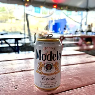 a can of modell beer on a picnic table