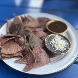 a plate of nachos with dipping sauce