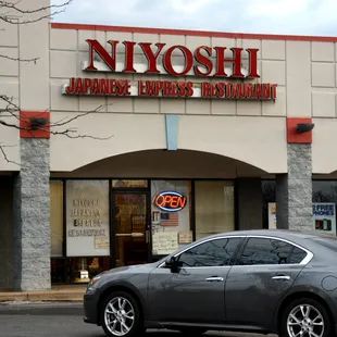 a car parked in front of a restaurant