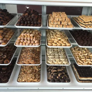 a variety of pastries in a display case