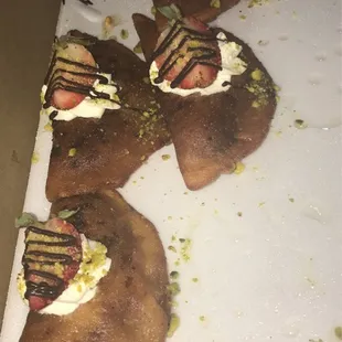 four pieces of bread with whipped cream and toppings