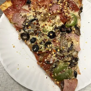 a slice of pizza on a paper plate