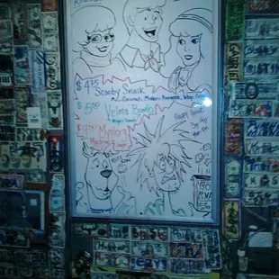 a whiteboard with cartoon characters on it