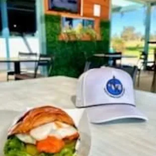 a sandwich and a hat on a table