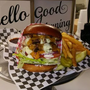 a hamburger and french fries on a checkered tray