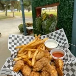 a basket of fried chicken and fries