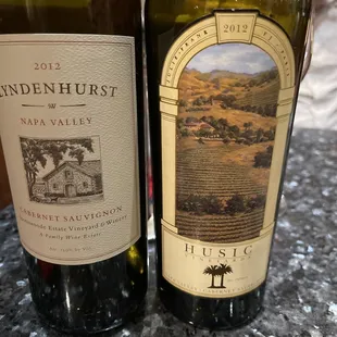 two bottles of wine on a countertop