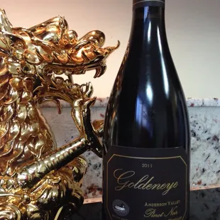 a bottle of wine and a golden dragon