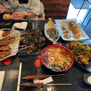 Flat chicken wings, silk worms, chinese hot dogs, lamb on skewers, egg plant, clams, cold noodles (sweet and sour summer dish).